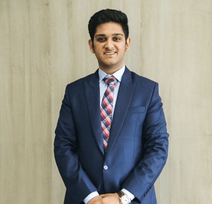 a man in a suit smiling